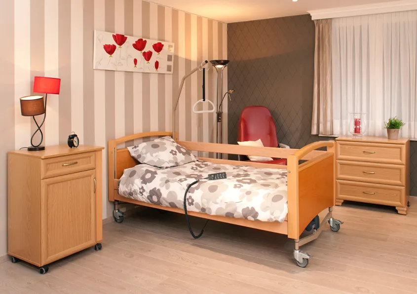 Bedroom fitted out with with care bed and hoist